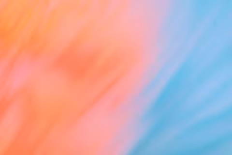 Blurred gradient with pastel orange and blue hues.
